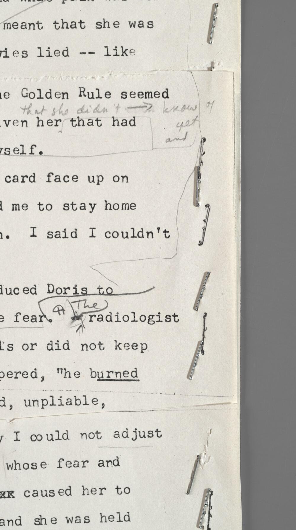 A close-up of a page, showing layers of paper containing different revisions.