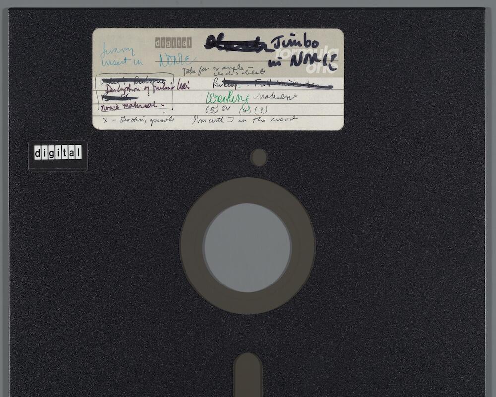 A close-up of a disk label, heavily marked, with JIMBO written prominently in black Sharpie.