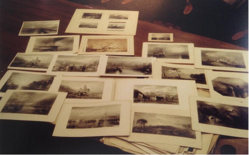 Photographs of prints on a wood table