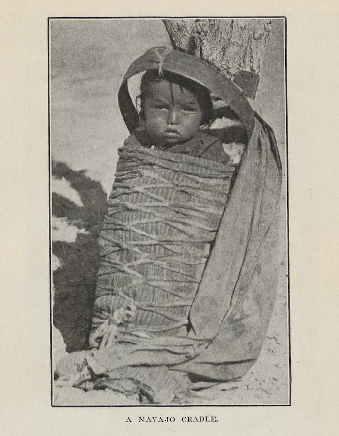 Baby in "Navajo cradle" propped on the ground