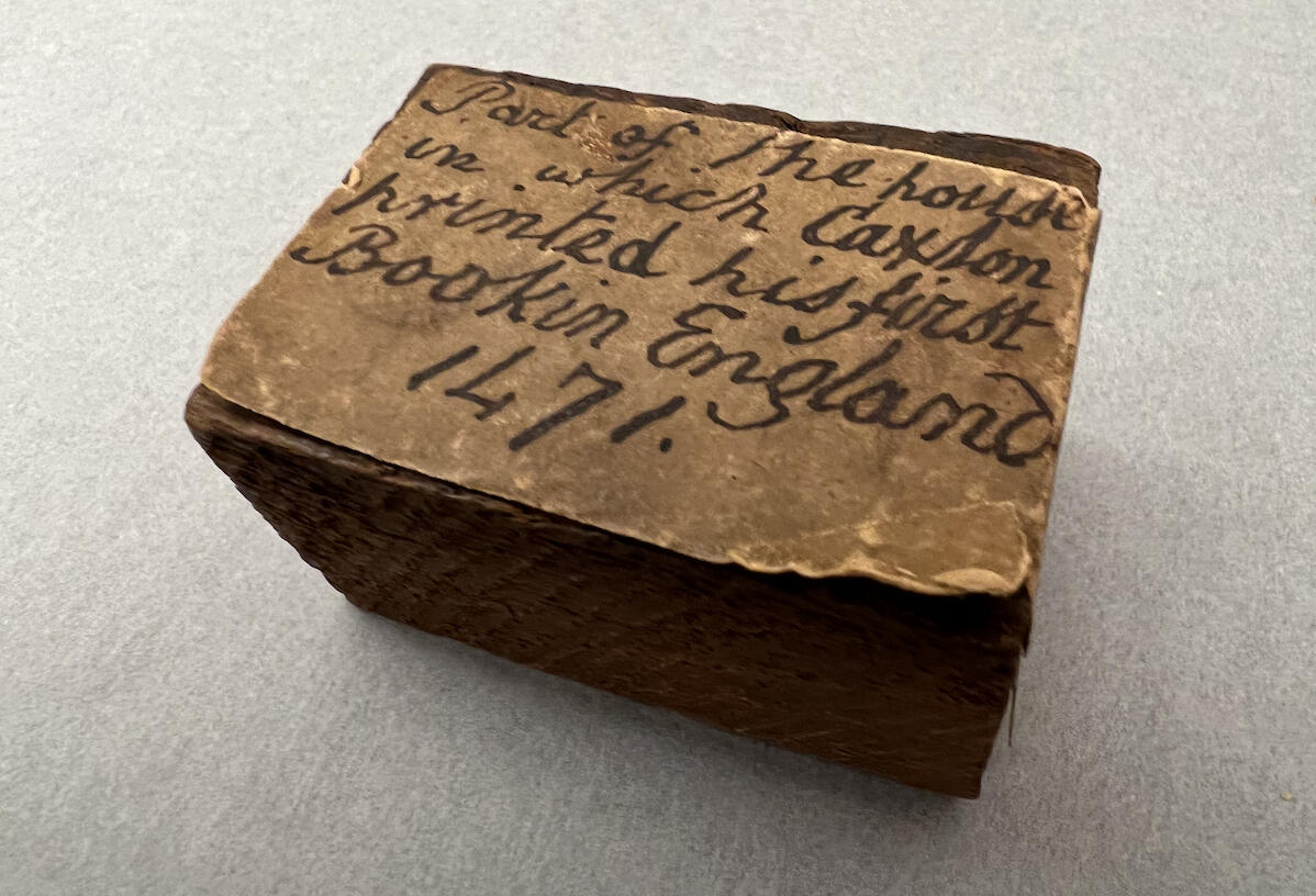 Wooden block with inscription "Part of the house in which Caxton printed his first Book in England. 1471."